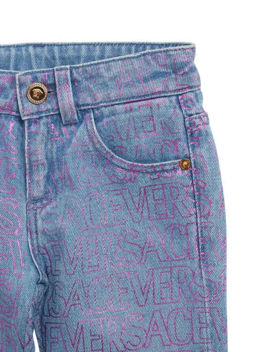 Versace   All over logo print cotton denim jeans 