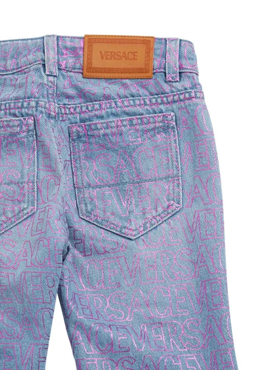 Versace   All over logo print cotton denim jeans 